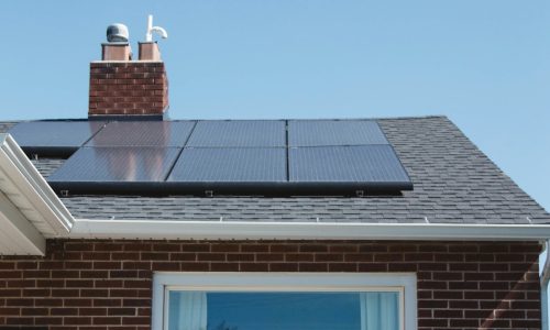 Solar panels installed on a residential roof, showcasing renewable energy solutions for electric vehicle charging and sustainability.